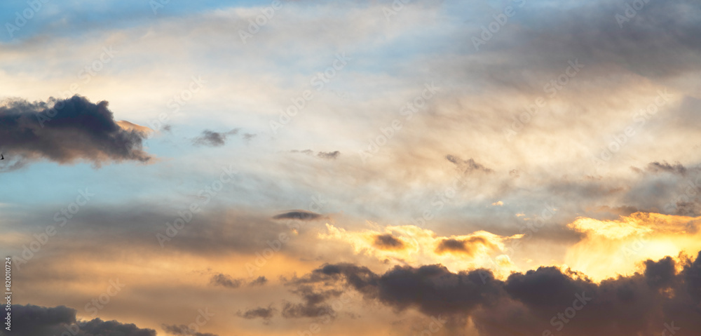 Wall mural sky background. bright orange sunset sky with clouds.