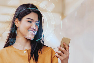 Female using mobile smartphone scanning  face ID to unlock phone security with facial recognition...
