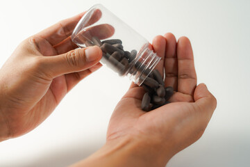 man pouring pills into hand white background