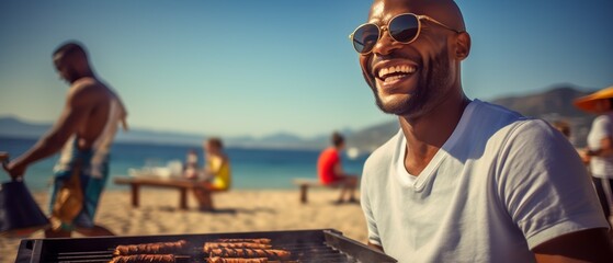 Fototapeta premium A man wearing sunglasses smiles while grilling at the beach, with other people relaxing in the background on a sunny day.