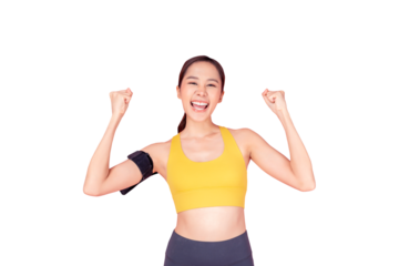 A cheerful young woman in a yellow sports bra and black workout pants celebrating her fitness achievement. She has a smartphone armband and is smiling brightly, exuding energy and motivation against a