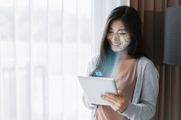 Female using mobile smartphone scanning  face ID to unlock phone security with facial recognition technology for identification, access to financial bank assets cash and money.