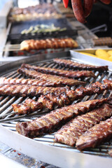 Electric grill in the food court at the fair. Large round rotating grill with assorted meats and vegetables. Rotary grill. Street food. Open air fair