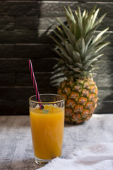 Mango drink with a straw in a glass. Refreshing drink, juice