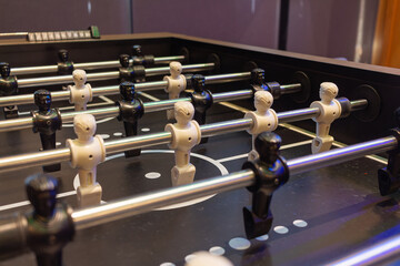 Football Table with White and Black Players on Opposite Sides