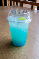 Refreshing Blue Drink with Yellow Fruit in Glass