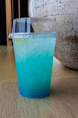 Refreshing Blue Drink with Yellow Fruit in Glass