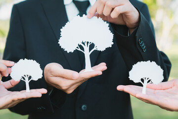 Group of business people holding white paper tree showcase environmental protection nurturing with...