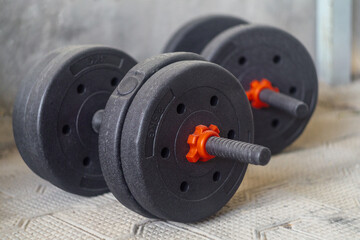 Black dumbbells with pancakes of 3 and 2 kilograms. Sports equipment for strength training