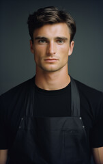 Obraz premium A man in a kitchen apron. Chef work in the cuisine. Cook in uniform, protection apparel. Job in food service. Professional culinary. Black fabric apron, casual stylish clothing. Baker. Generated AI
