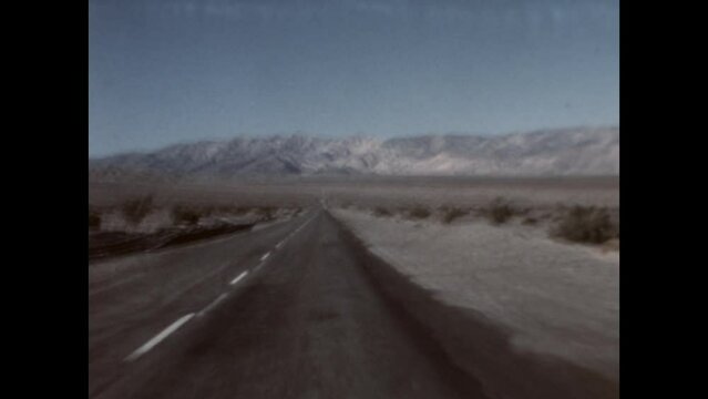 Desert Drive, Mountain View 1970 - Mountains in Death Valley National Park are seen from a car driving through the desert in 1970. 