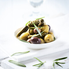 Various olives on white wooden background. Close up. Copy space	