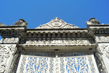 Close-up of the gate of the Istanbul Küçüksu Palace. Bottom-up view of the fence and metal doors with beautiful Baroque ornaments