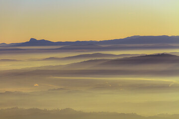 Enchanting Misty Mountain Sunrise with Layered Fog