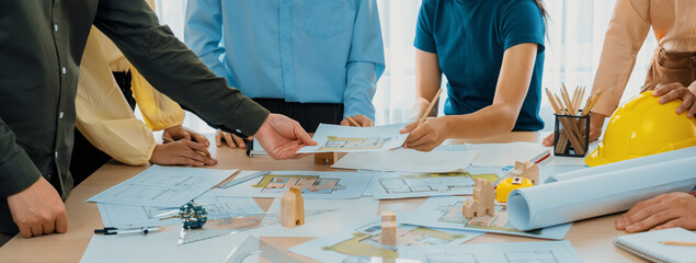 Professional architect engineer team discussion about architectural project on meeting table with...