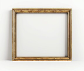 Fototapeta premium An elegant, empty gold picture frame leaning against a white wall, perfect for showcasing artwork or photography in a minimalist setting..