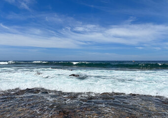 Atlantic ocean view from a rocky beach in south of Tenerife, canary islands. Horizon over sea and blue sky. Vacation, tourism, travel destination