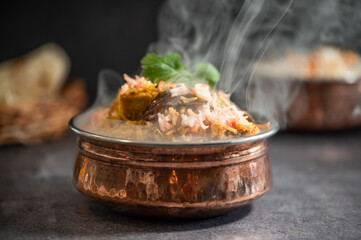 Smoky Spicy Indian biryani pulao in golden bowl with India basmati rice