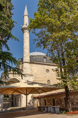 A beautiful view of the Shepherd Mustafa Pasha Mosque and Complex from the outside in a sunny weather. View of the dome and minaret.