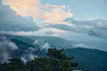 Obraz premium Scenic Mountain Top View with Clouds and Trees in Foreground, Serene Nature Landscape Travel Photography Concept