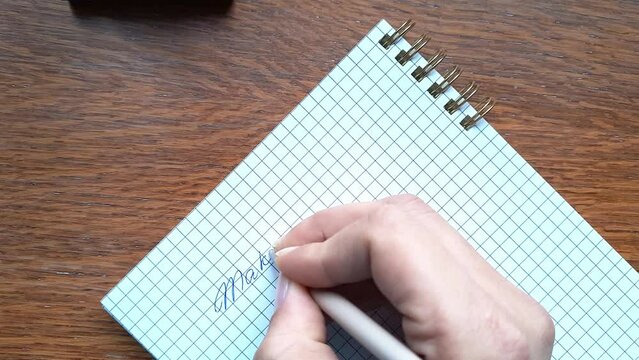 Woman writes phrase in her notebook Make a difference. Fingers close up top view. call to action, positive changes in the world or in people's lives. Lifestyle new life