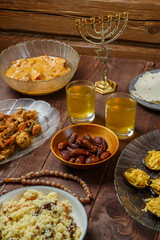 Shabbat table for a family dinner with traditional holiday dishes and drinks. Vertical photo.