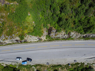 Drone photo. View from above of a Norwegian mountain with a highway running along it with a rest...