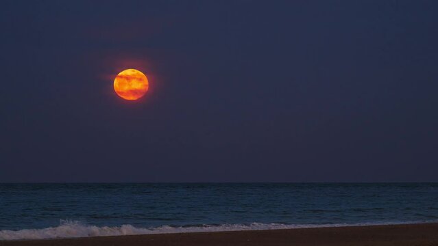 April pink moon rising over the Atlantic Ocean, shot from an Outer Cape Cod beach, timelapse video