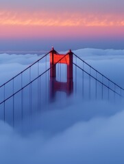 Golden Gate Bridge's tower emerges from dawn fog, iconic red against soft blue sky