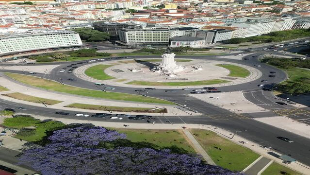 Aerial drone view approaching Marquis of Pombal Square roundabout in Lisbon, Portugal from Eduardo XII Park in vertical mode