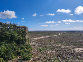 Vast Barren Landscape with a Single Overgrown Structure and Clear Blue Sky. Central Portugal