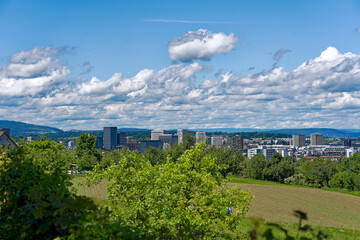 Scenic landscape with skyline and skyscrapers int the background at Swiss City of Zürich north part on a sunny spring day. Photo taken May 19th, 2024, Zurich, Switzerland.