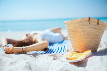Closeup on modern 40 years old woman on ocean shore