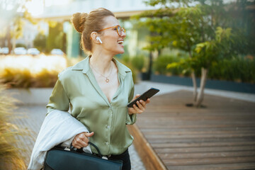 business woman using phone and walking