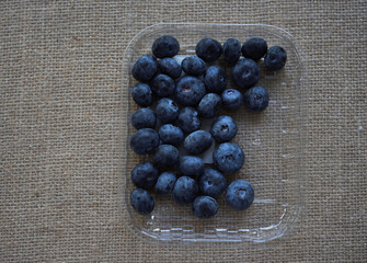 Large juicy blueberries on the background of burlap. Wild berries. Fresh blueberries.