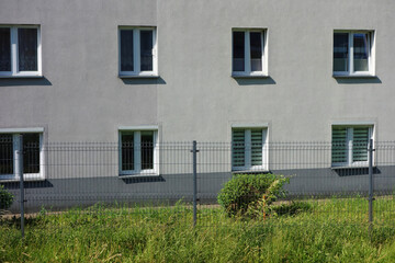 A new block of flats behind the fence.