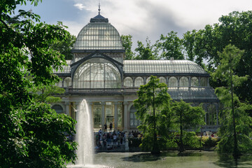 Photograph of the Crystal Palace in El Retiro park. Architecture. City of Madrid. Green area. European tour