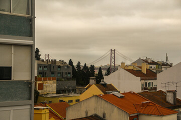 Overview of a low-rise neighborhood in Lisbon, Portugal. Vasco da Gama Bridge in the background.