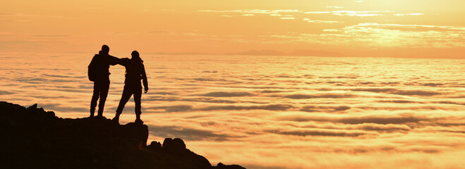 People Welcoming the Sunrise at the Summit