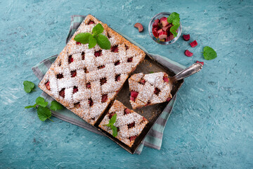 Traditional rhubarb sheet cake with spelt flour served as top view on a Nordic Design plate