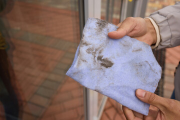 A person is using a cloth to clean a window