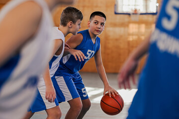 A young basketball team is practicing basketball game playing.