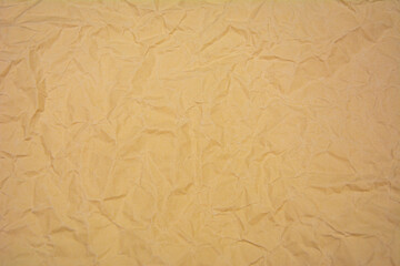 Beige color background with dense wrinkles. Beige color recycled kraft paper texture as background.