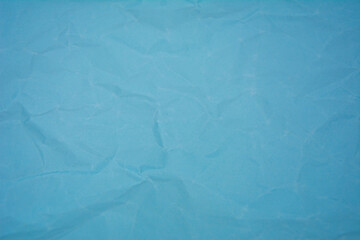 Light blue color background with little wrinkles. Light blue color recycled craft paper texture as background.