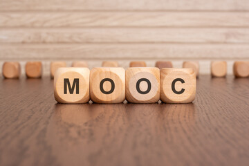 the text MOOC is written on wooden cubes on a brown background