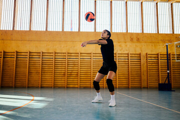 Portrait of a woman volleyball player receiving a ball with a bump