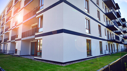 The garden of a modern residential building with a green lawn and a place to relax.
