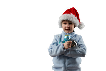 Christmas Eve. A child in Santa Claus hat with glass Christmas tree balls in his hands. Png.