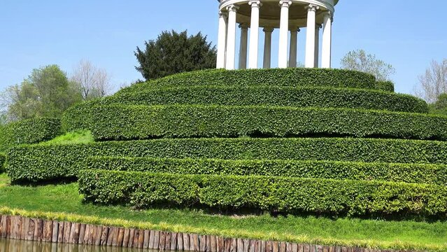 Parco Querini is green area of city of Vicenza, Italy. Monopteros is circular colonnade supporting roof but without any walls. Unlike tholos, it does not have walls making cella or room inside.