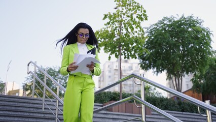 Young lady rushing to business meeting with papers